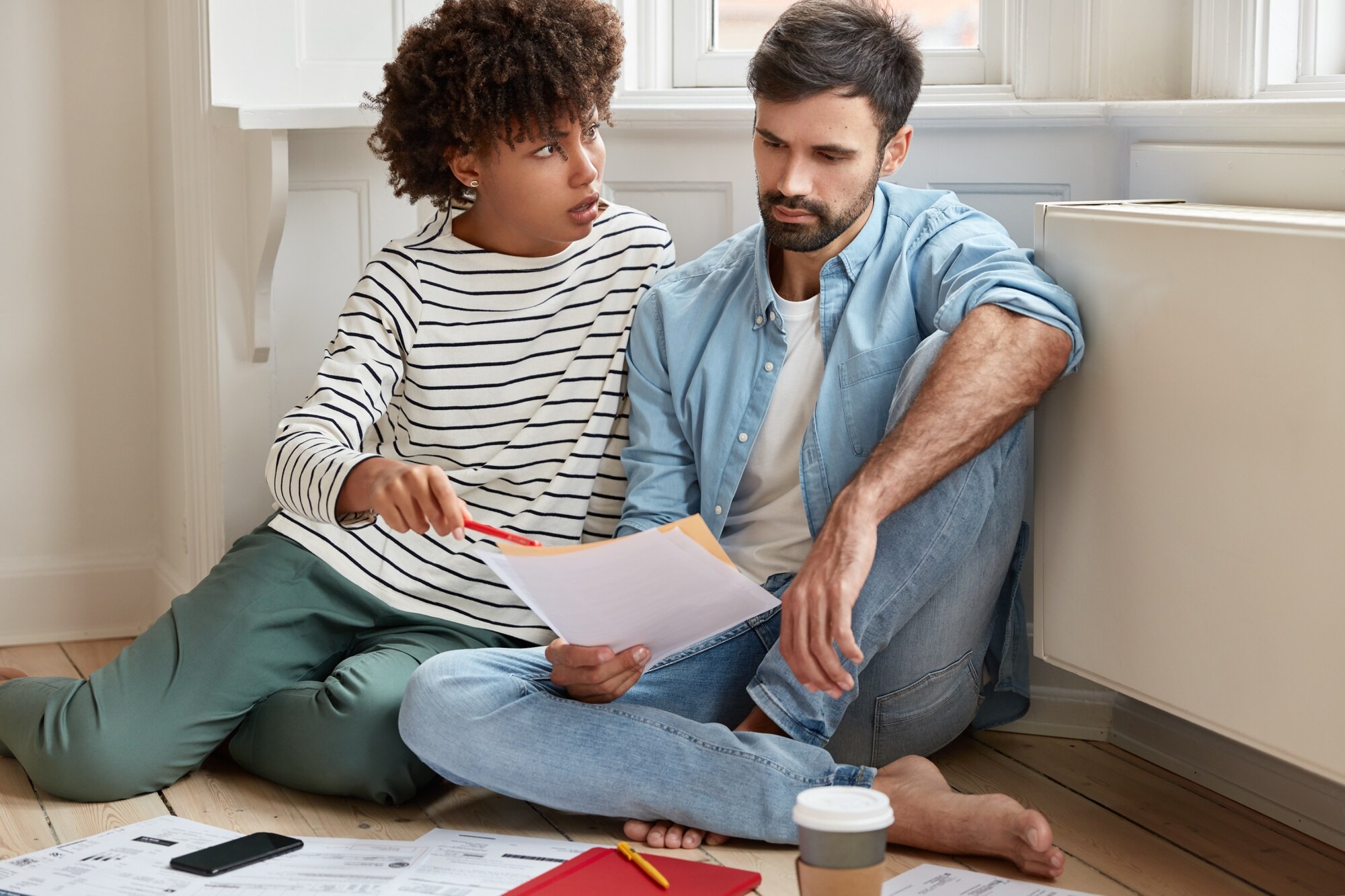 How to Sell Your House in 5 Days displeased dark skinned businesswoman convinces her husband to pay attention at some figures in financial report