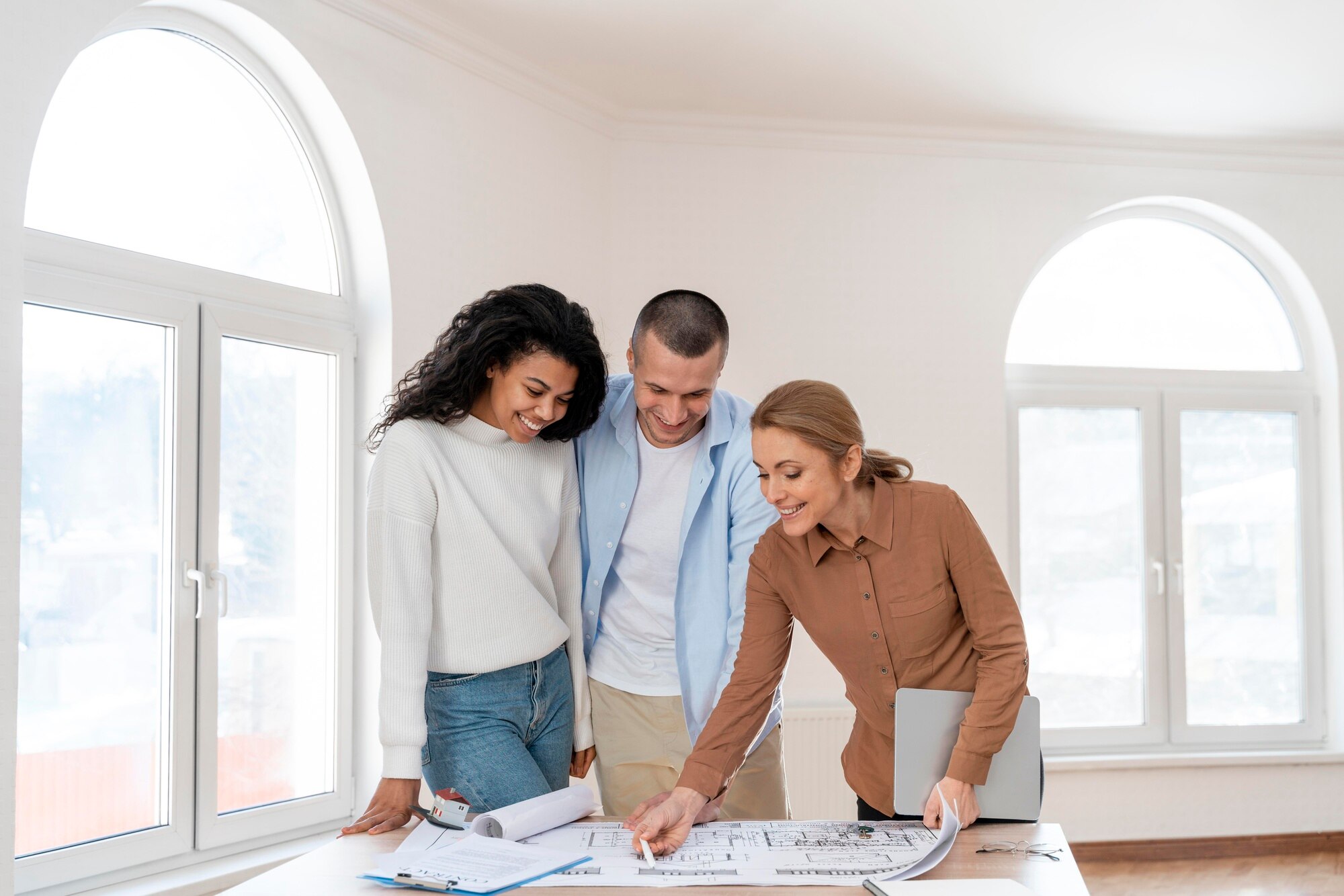 Short Sales and Credit Reports front view of female realtor showing new house plan to couple