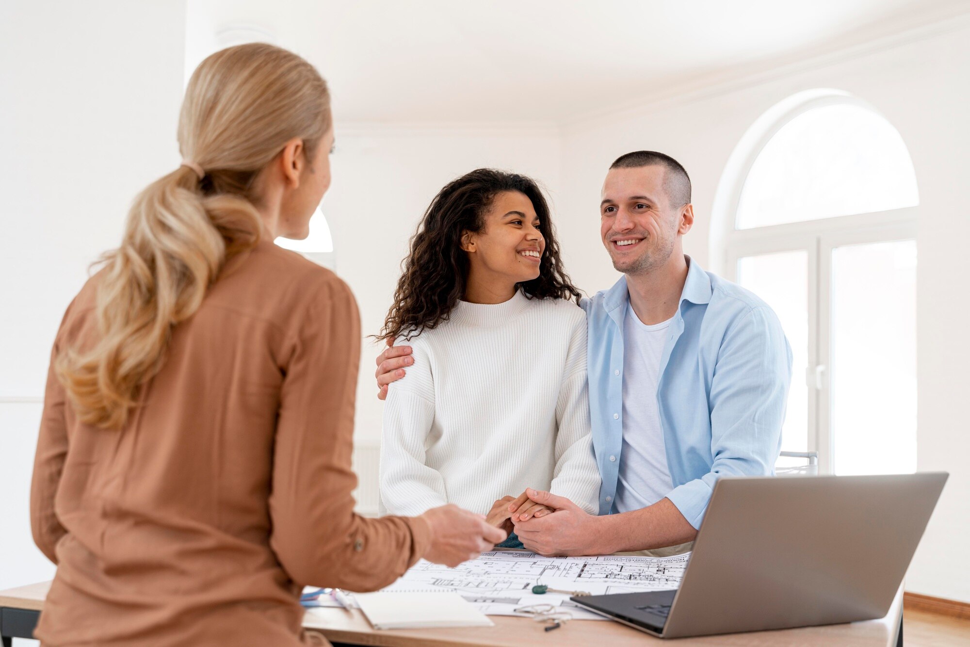 Average Real Estate Commission in California happy embraced couple conversing with female realtor