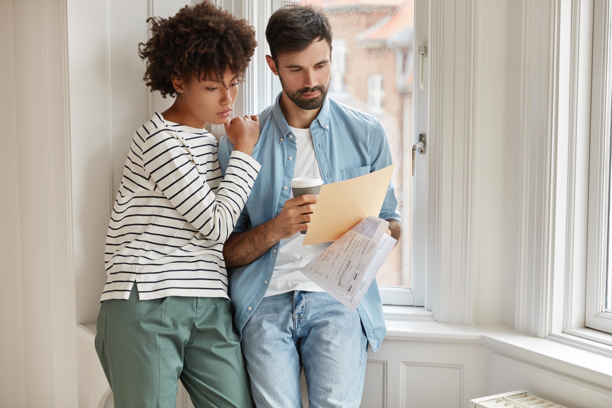 How to Sell Your House in 5 Days interracial young woman and man make accounting of their expenses for year concentrated on paper work