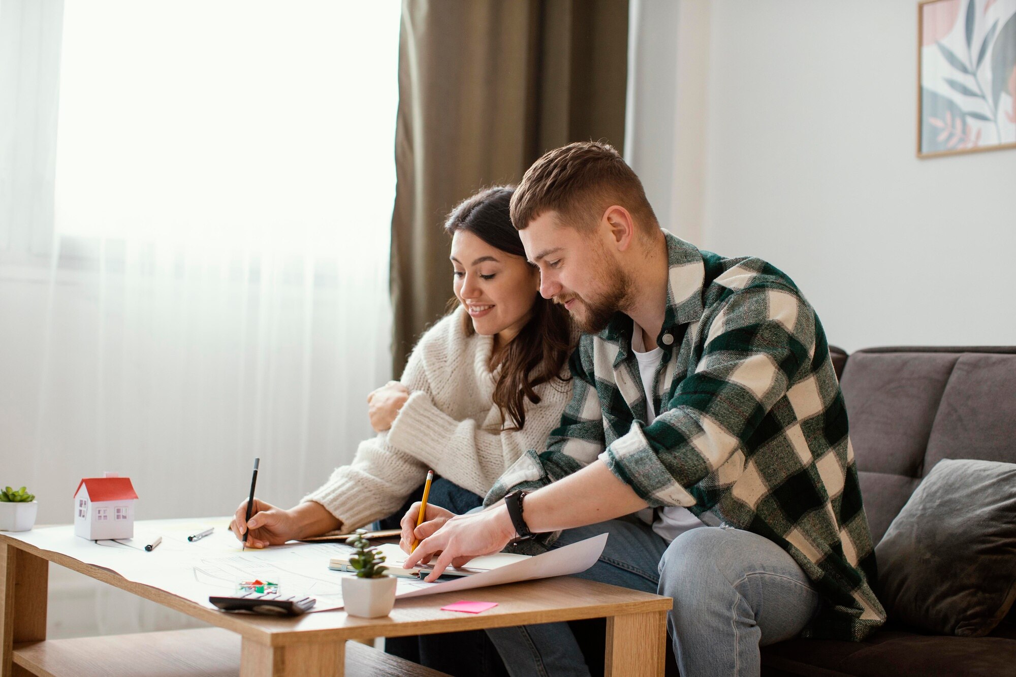 Short Sales and Credit Reports medium shot couple sitting on couch