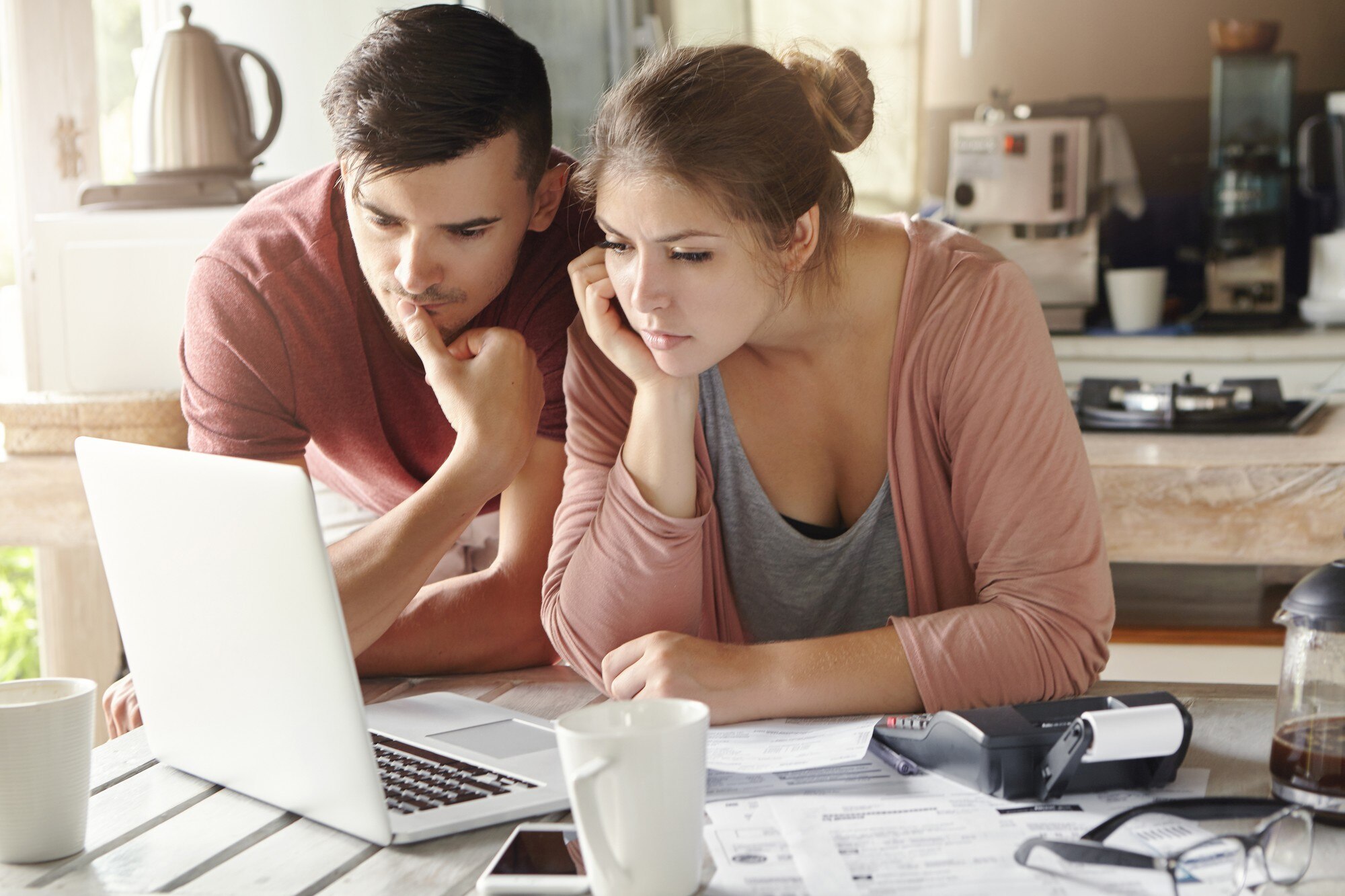 How to Sell Your House in 5 Days serious man and woman sitting at kitchen table in front of open laptop