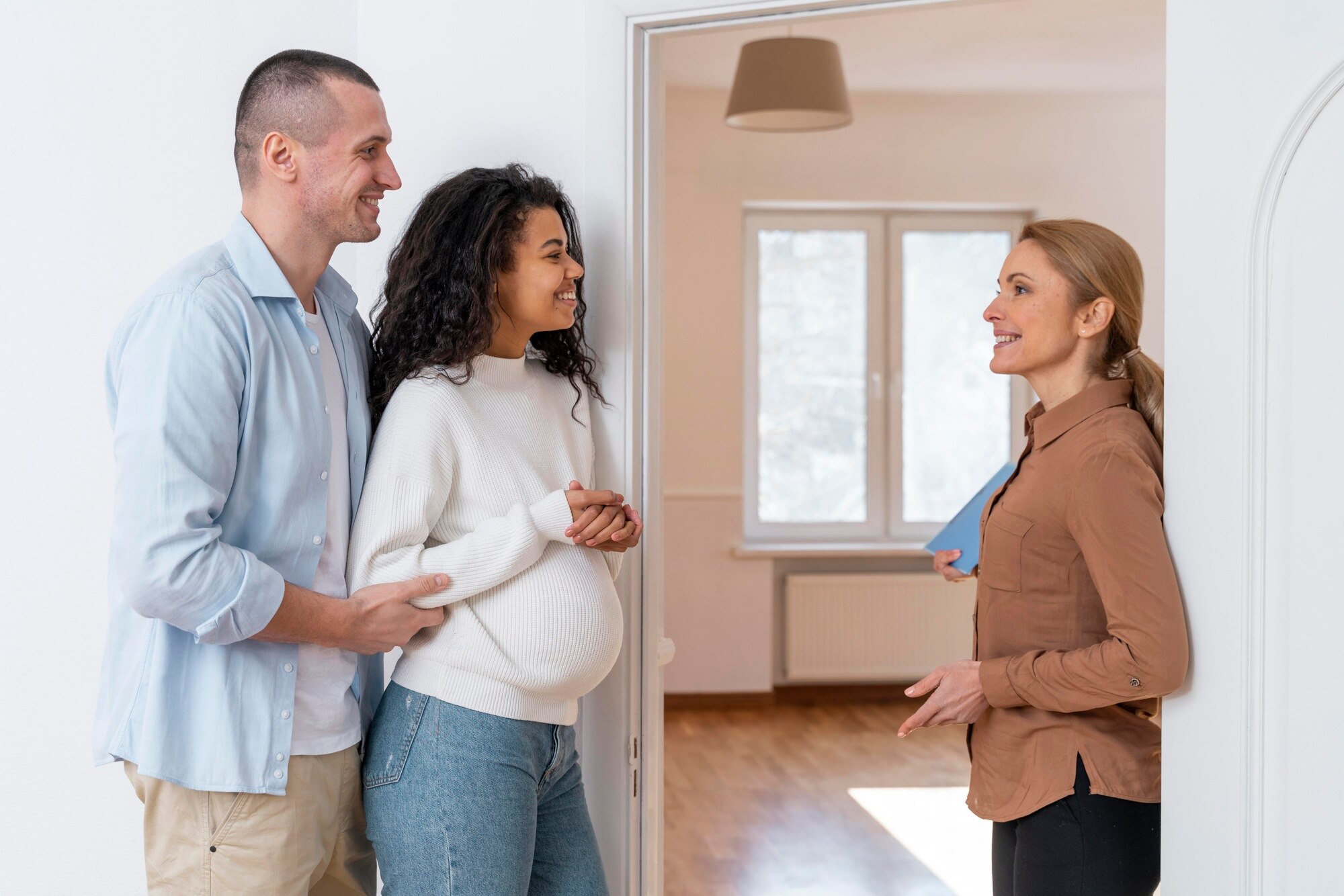 Selling Your Home With Opendoor: A Comprehensive Guide side view of realtor inviting couple in to see new house