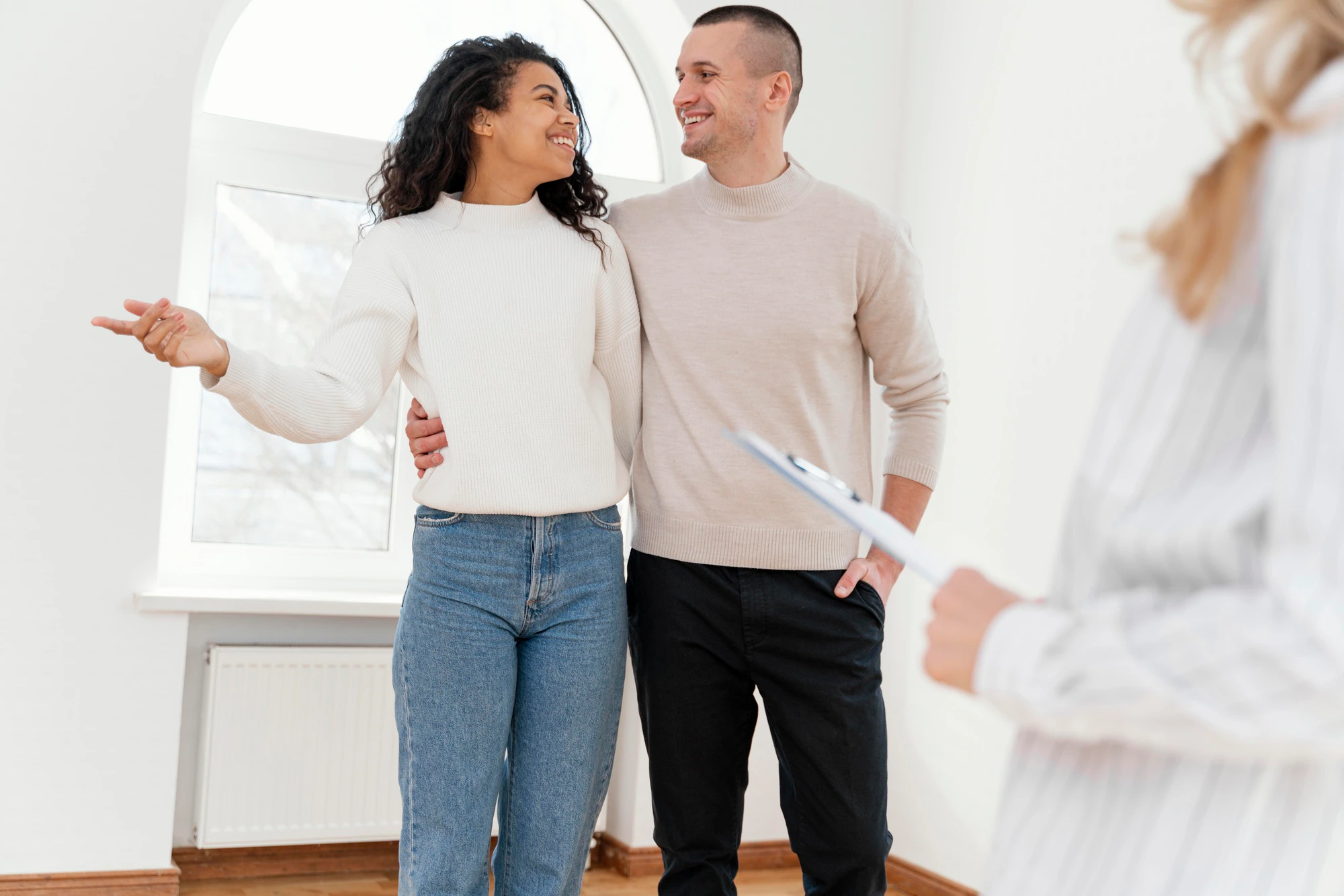 Short Sales and Credit Reports smiley couple seeing new house with female realtor