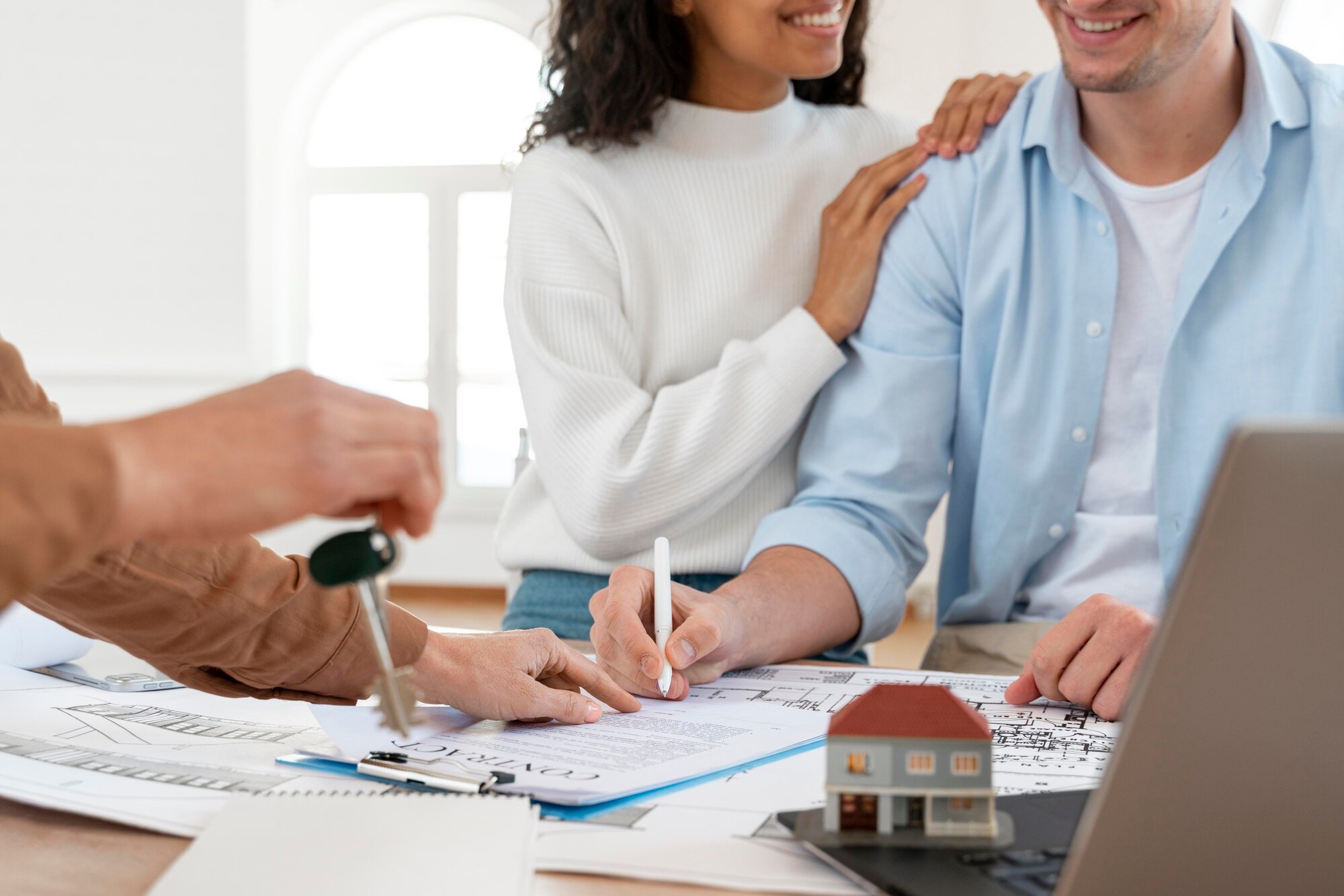 Cash Home Buyers in Los Angeles: A Comprehensive Guide smiley couple signing contract for new house